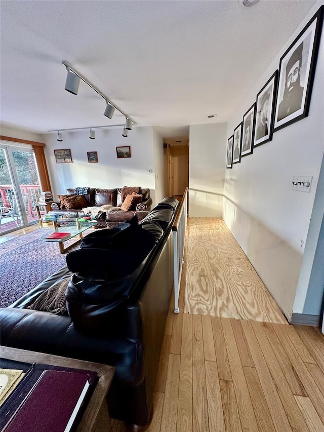 living room with hardwood / wood-style floors and rail lighting