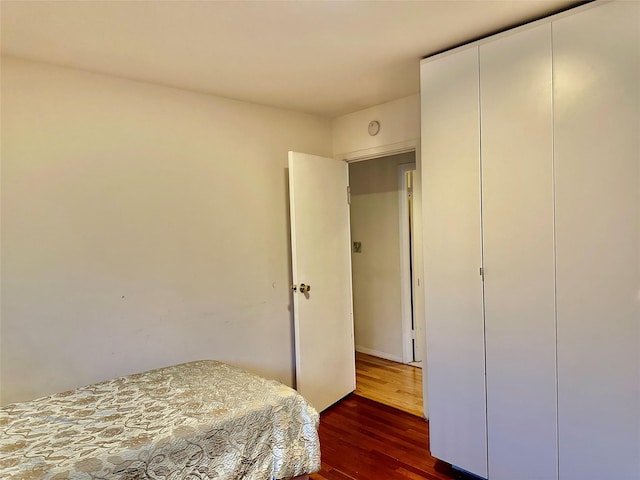 bedroom featuring dark hardwood / wood-style flooring