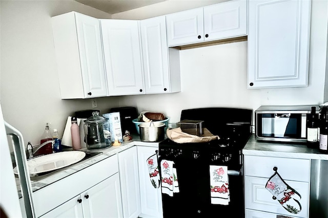 kitchen featuring white cabinetry and sink