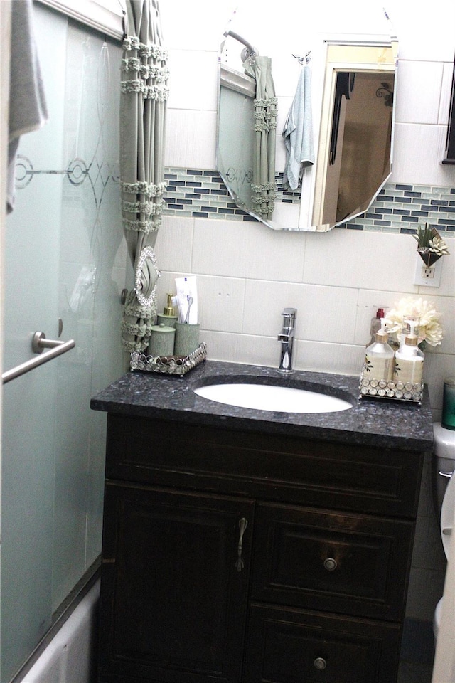 bathroom featuring decorative backsplash, vanity, and toilet