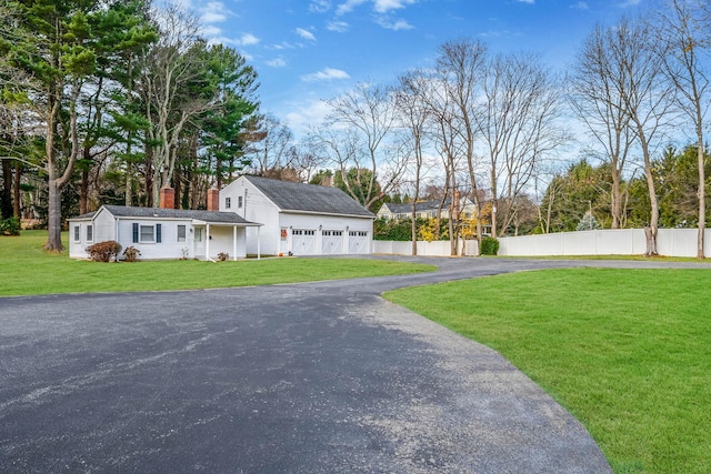 exterior space featuring a garage and a yard