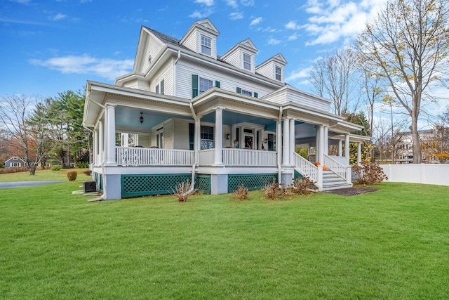 view of front of house featuring central AC, a porch, and a front yard