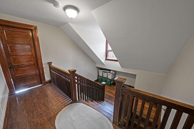 corridor featuring dark hardwood / wood-style flooring and lofted ceiling