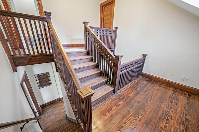 stairs featuring hardwood / wood-style floors