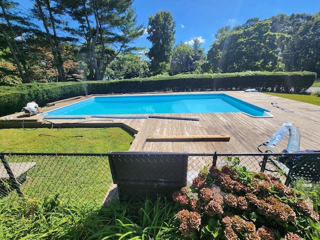 view of pool featuring a yard and a deck with water view