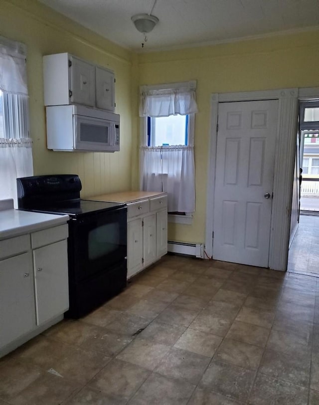 kitchen featuring black / electric stove, a wealth of natural light, white cabinets, and a baseboard heating unit