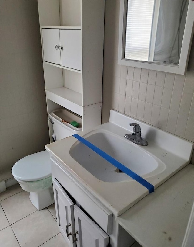 bathroom featuring tile patterned flooring, vanity, and toilet