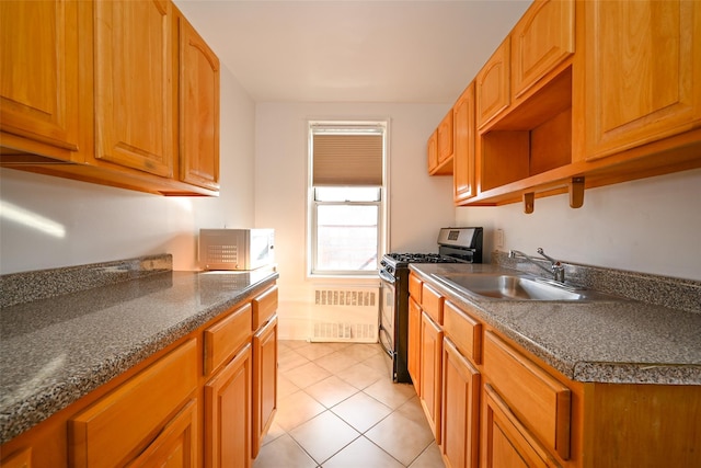 6535 Broadway Unit 6A, Bronx, NY 10471 - kitchen with gas stove, white microwave, light tile patterned floors, dark countertops, and brown cabinetry