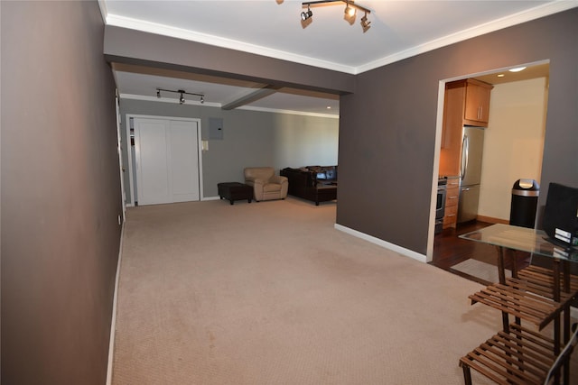 interior space featuring crown molding, beamed ceiling, and rail lighting