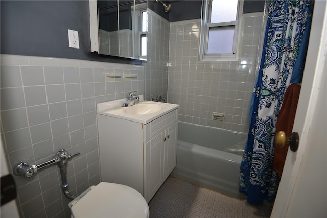 full bathroom featuring vanity, tile patterned flooring, toilet, tile walls, and shower / tub combo