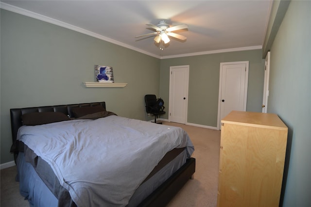 carpeted bedroom featuring ceiling fan and crown molding