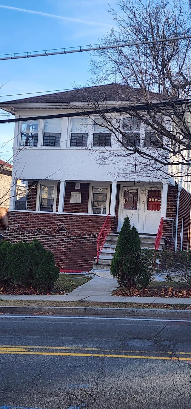 view of property featuring covered porch