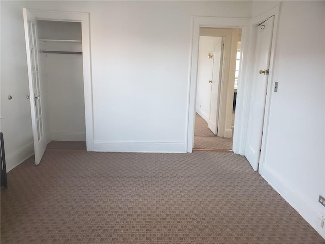 unfurnished bedroom featuring carpet floors and a closet