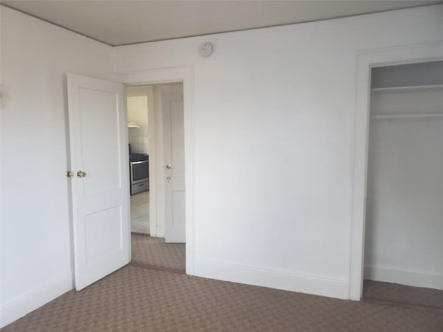 unfurnished bedroom with carpet floors and a closet