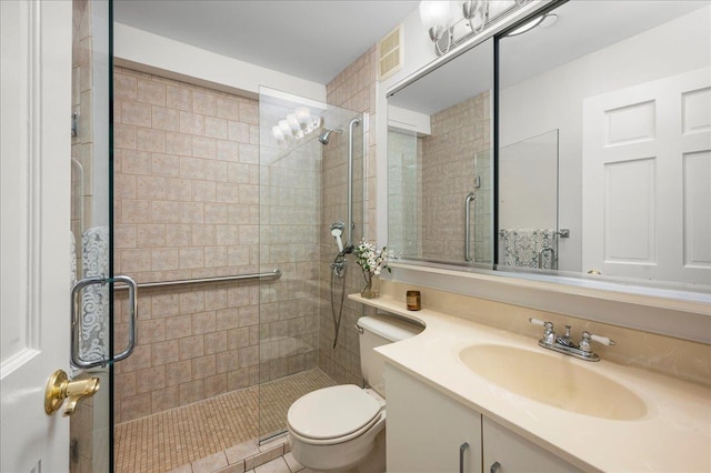 bathroom with an enclosed shower, vanity, and toilet