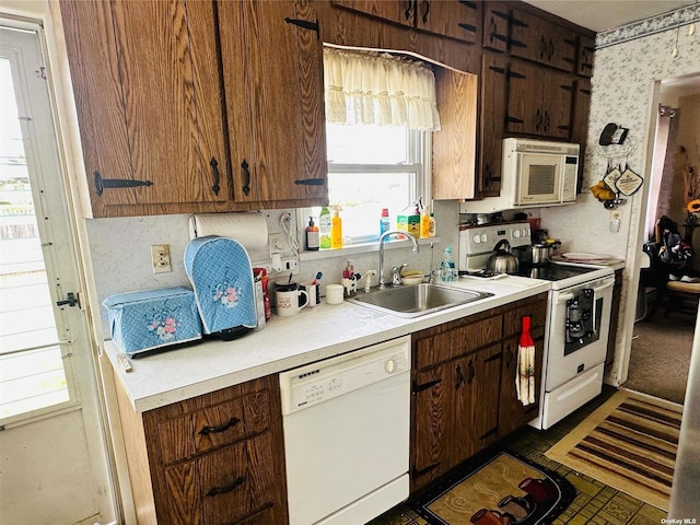 kitchen featuring white appliances and sink