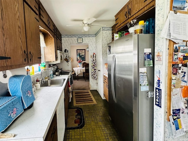kitchen featuring ceiling fan, white appliances, and sink