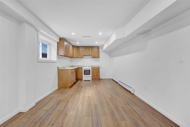 kitchen with white range, light hardwood / wood-style floors, baseboard heating, and sink