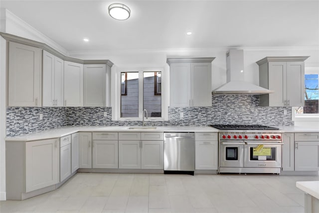 kitchen featuring premium range hood, ornamental molding, stainless steel appliances, sink, and gray cabinets