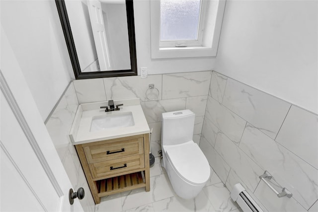 bathroom featuring vanity, a baseboard radiator, toilet, and tile walls