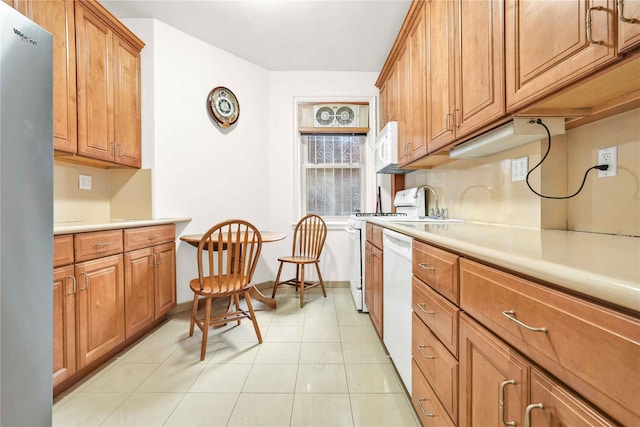 kitchen with light tile patterned floors and white appliances