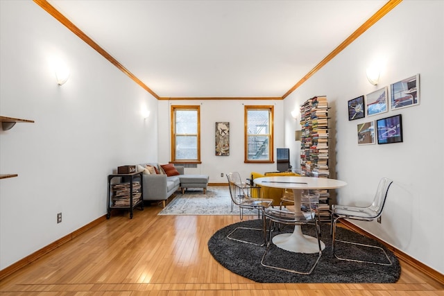 dining space featuring hardwood / wood-style flooring and ornamental molding