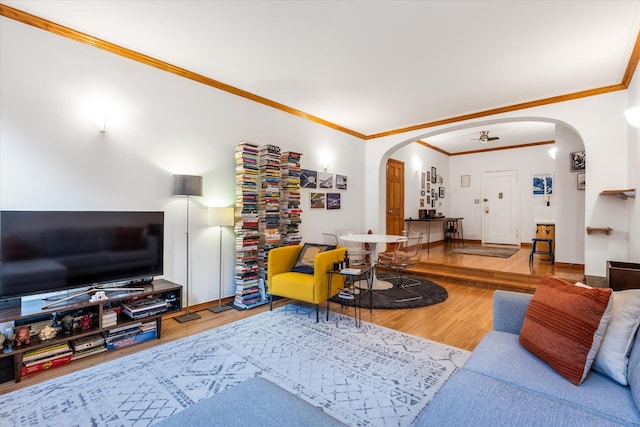 living room with hardwood / wood-style floors and crown molding