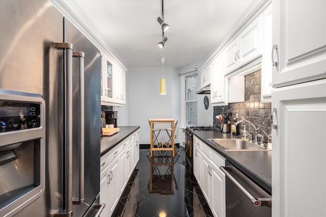 kitchen featuring white cabinets, sink, tasteful backsplash, decorative light fixtures, and stainless steel appliances