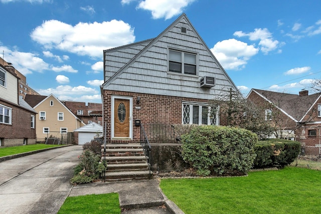 view of front facade featuring an AC wall unit, an outbuilding, a front lawn, and a garage