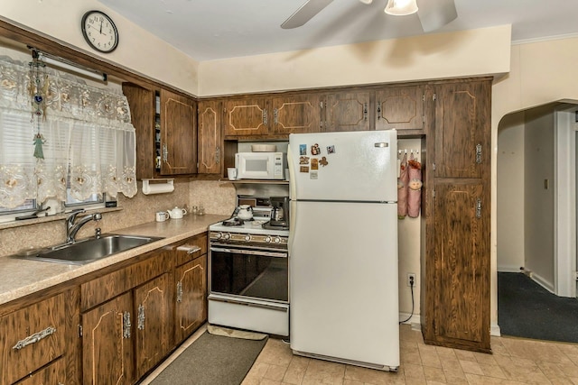 kitchen featuring tasteful backsplash, ceiling fan, sink, and white appliances