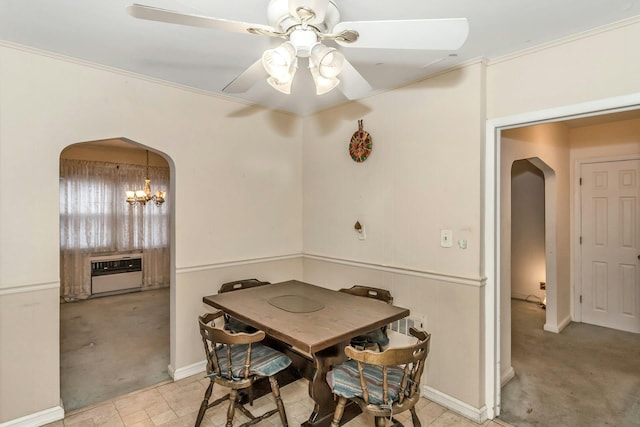 carpeted dining area with heating unit, crown molding, and ceiling fan with notable chandelier