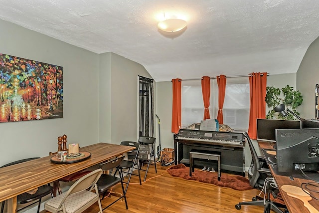 office area with hardwood / wood-style floors, a textured ceiling, and vaulted ceiling