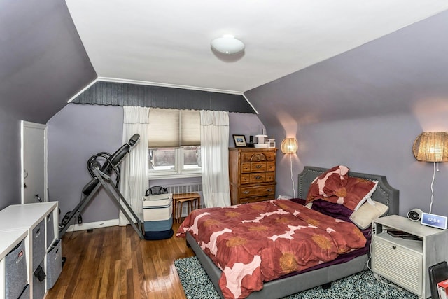 bedroom featuring dark hardwood / wood-style flooring and vaulted ceiling