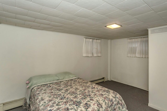 carpeted bedroom featuring a baseboard heating unit