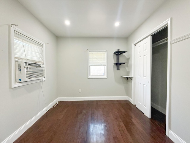 unfurnished bedroom featuring dark wood-type flooring and a closet