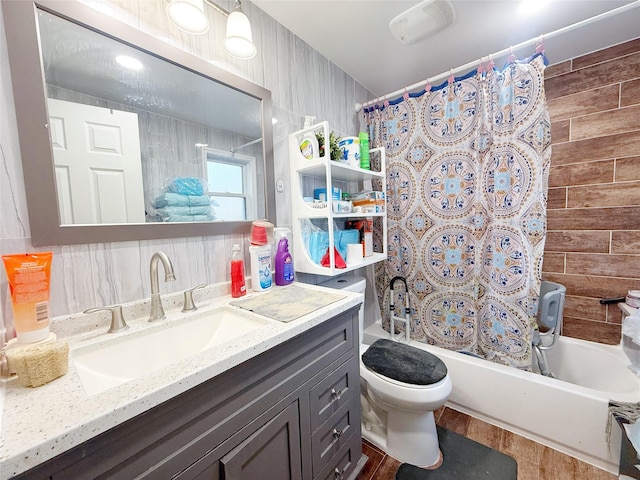 full bathroom featuring shower / bath combo, hardwood / wood-style floors, toilet, vanity, and tile walls