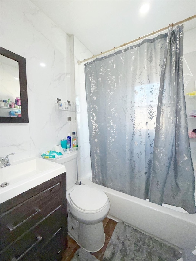 full bathroom with shower / bath combo, vanity, and toilet