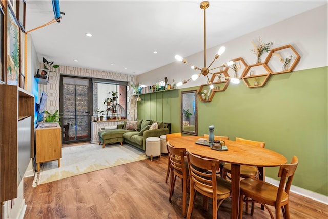 dining room featuring light hardwood / wood-style flooring and a notable chandelier