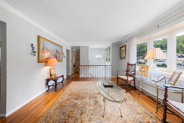 sitting room featuring crown molding, a notable chandelier, and hardwood / wood-style flooring