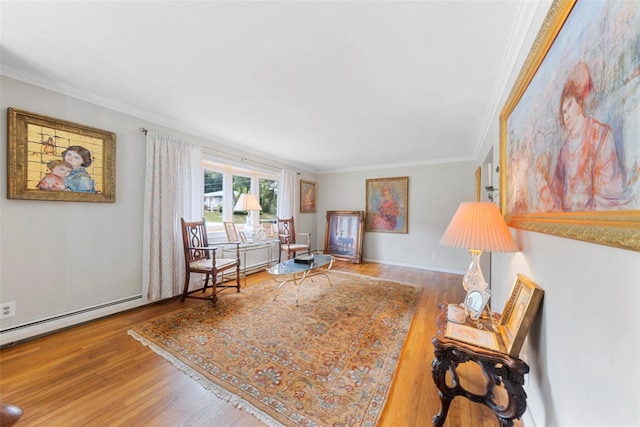 sitting room featuring hardwood / wood-style flooring, baseboard heating, and ornamental molding