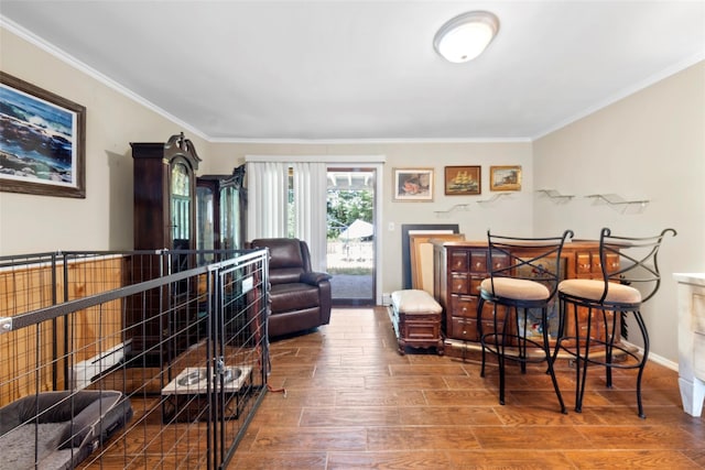 sitting room with hardwood / wood-style floors and ornamental molding