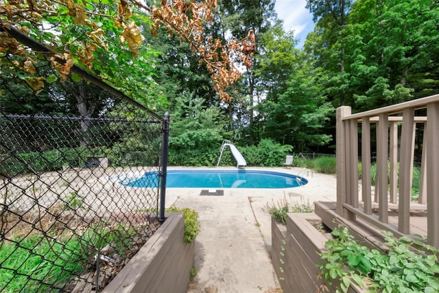 view of pool featuring a patio and a water slide