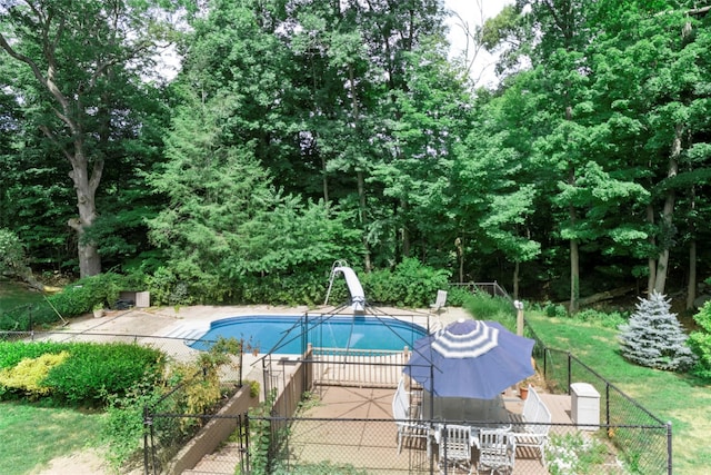 view of pool featuring a water slide and a patio