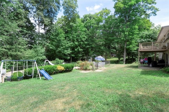 view of yard featuring a playground and a deck