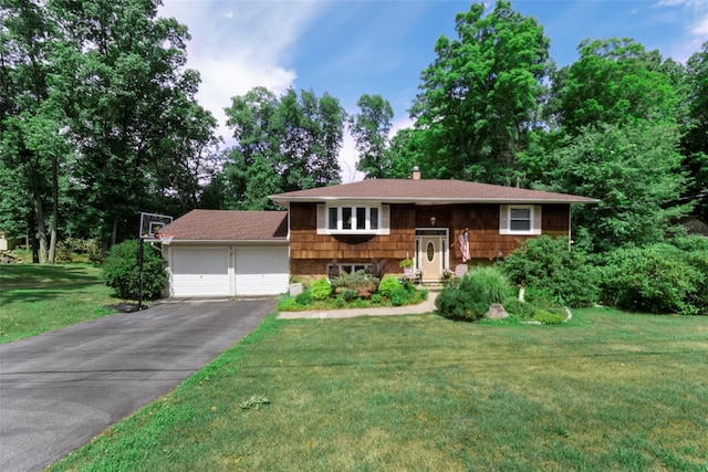 split foyer home with a front yard and a garage