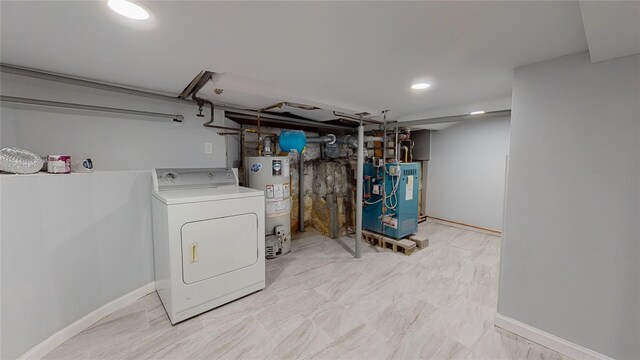 clothes washing area featuring washer / clothes dryer and water heater