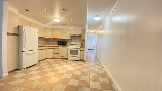 kitchen with decorative backsplash, sink, white appliances, and crown molding