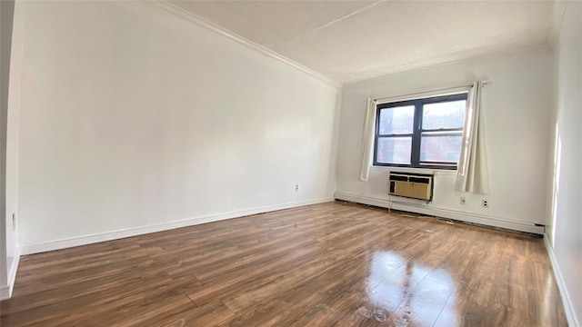 unfurnished room featuring dark hardwood / wood-style flooring, a baseboard radiator, a wall mounted AC, and ornamental molding