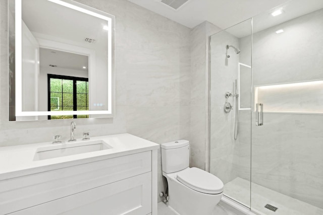 bathroom with vanity, toilet, an enclosed shower, and tile walls