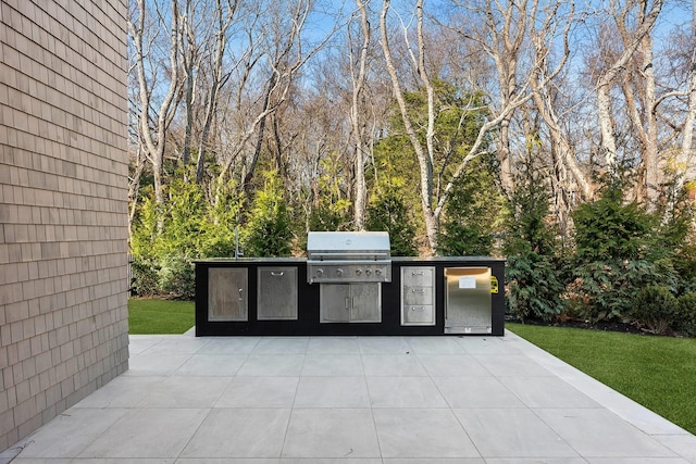 view of patio / terrace featuring exterior kitchen and a grill